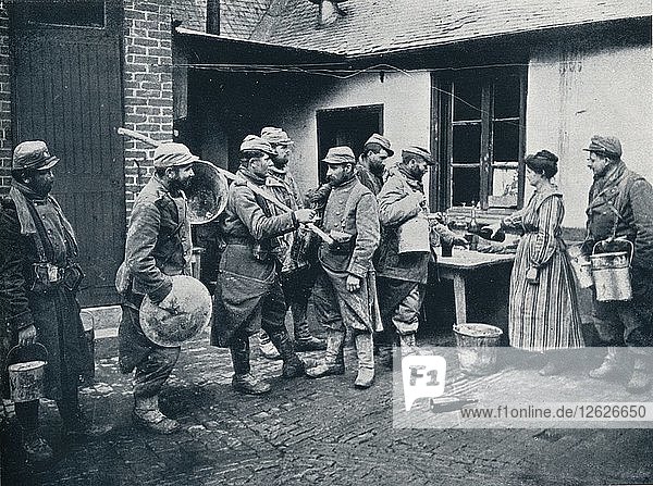 French soldiers returning from the trenches make a halt for refreshment c1914. Artist: Unknown