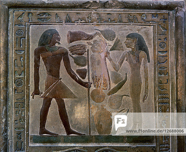 Door shaped stela representing Senouret and his wife in front of their offerings  made in polychr?