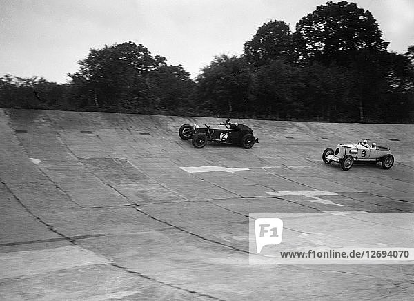 Invicta and Vauxhall 30/98 racing on the banking at an Inter-Club Meeting  Brooklands  20 June 1931. Artist: Bill Brunell.