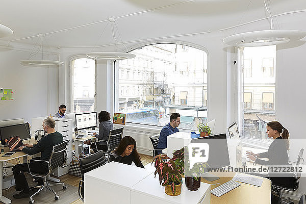 High angle view of business people working at desk in office