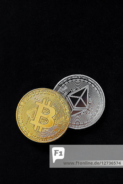 Ethereum and bitcoin on black background