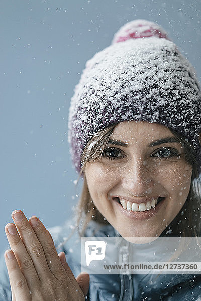 Woman wearing woolly hat in snow  portrait