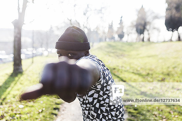 Young man exercising to box in park