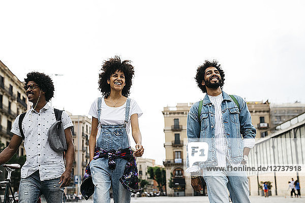 Spain  Barcelona  three friends walking together in the city