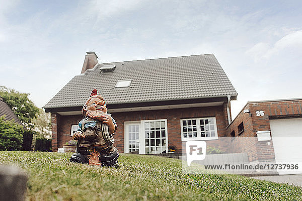 Garden gnome in garden of one-family house