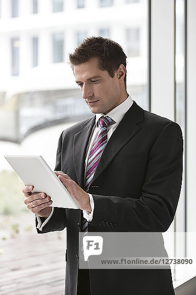 Poland  Warzawa  young businessman using tablet computer