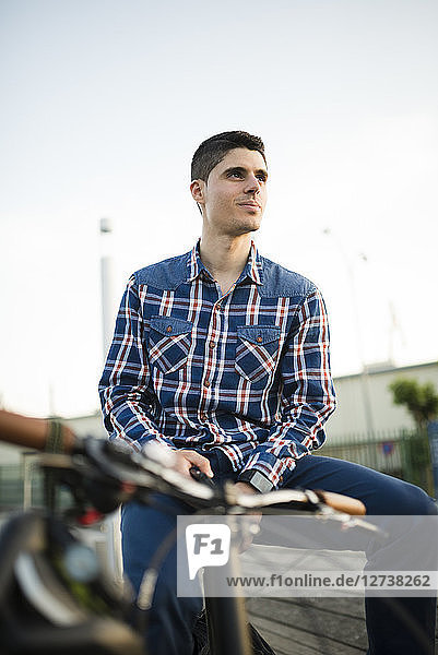 Young man with bicycle outdoors