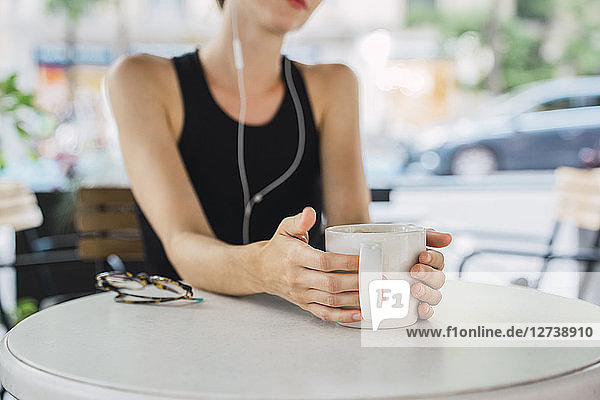 Young businesswoman sitting in coffee shop  taking a break  drinking tea