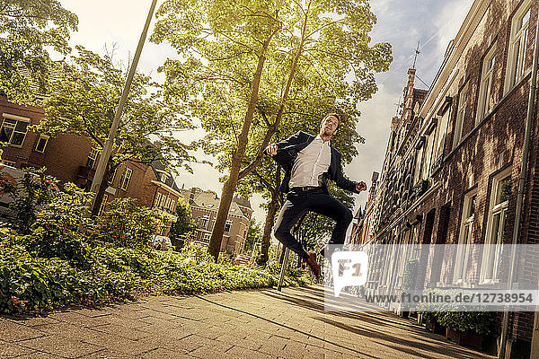 Netherlands  Venlo  businessman jumping on pavement
