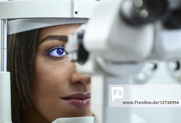 Optician  Young woman during eye test