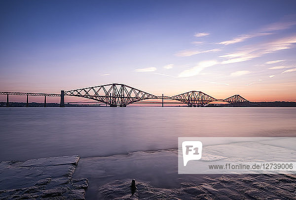 UK  Scotland  Fife  Edinburgh  Firth of Forth estuary  Forth Bridge  Forth Road Bridge and Queensferry Crossing in the background at sunset