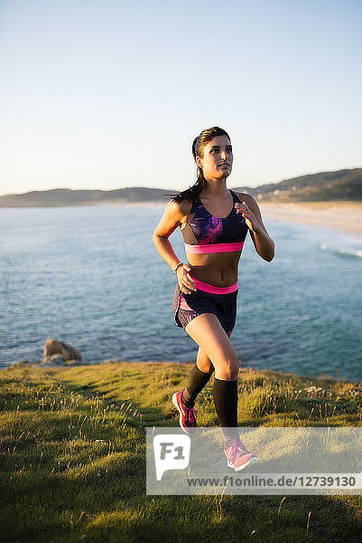 Young woman running on the coast