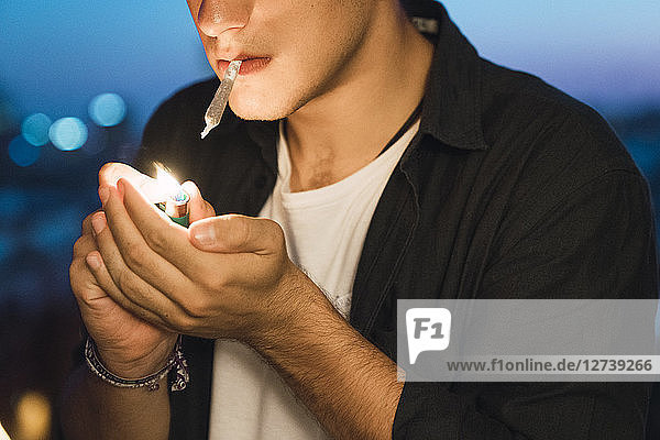 Young man smoking a joint