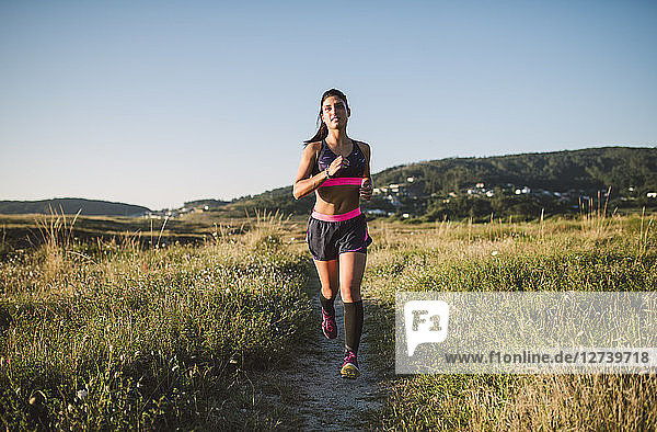 Sportswoman jogging on path