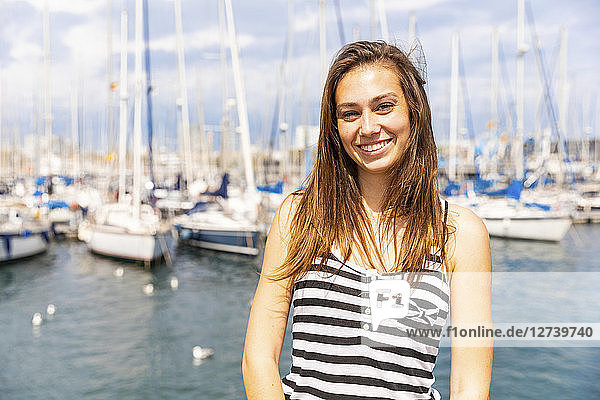 Portrait of smiling young woman at a marina