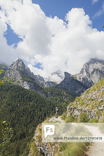 Italy  Trentino  Brenta Dolomites  Parco Naturale Adamello Brenta  woman enjoying mountain scenery on trail along Croz dell' Altissimo