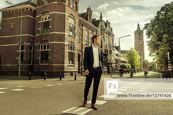 Netherlands  Venlo  businessman walking on a street
