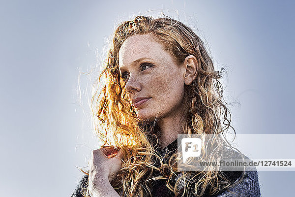 Portrait of redheaded woman outdoors