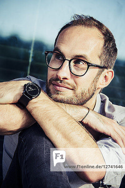 Portrait of bearded man wearing glasses and writs watch