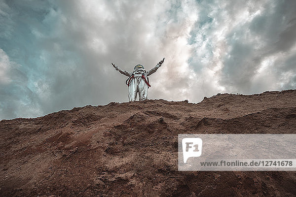 Spaceman standing on slope of nameless planet