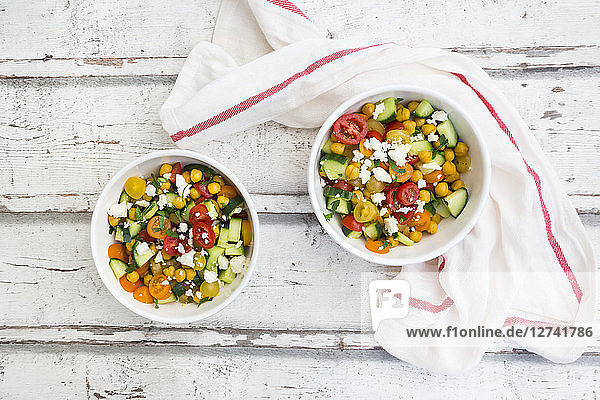 Bowl of salad with chick peas roasted with curcuma  feta  cucumber  tomatoes and parsley