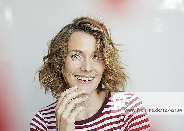 Portrait of smiling woman wearing red-white striped t-shirt