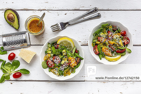 Lamb's lettuce with colorful tomato  avocado  parmesan and curcuma lemon dressing