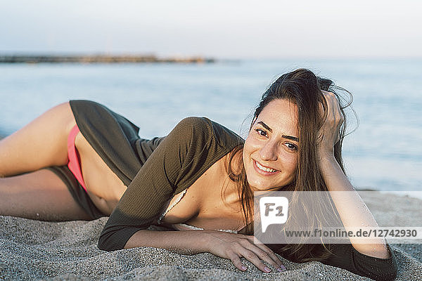 Beautiful woman relaxing on the beach at sunset  portrait