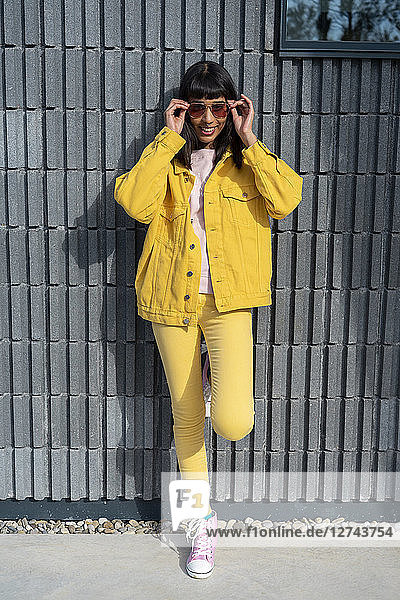 Young woman wearing yellow jeans clothes