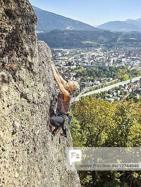 Austria  Innsbruck  Hoettingen quarry  woman climbing in rock wall