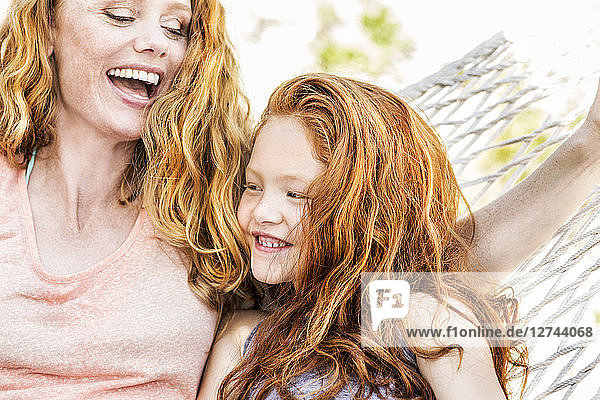 Happy mother and daughter in hammock