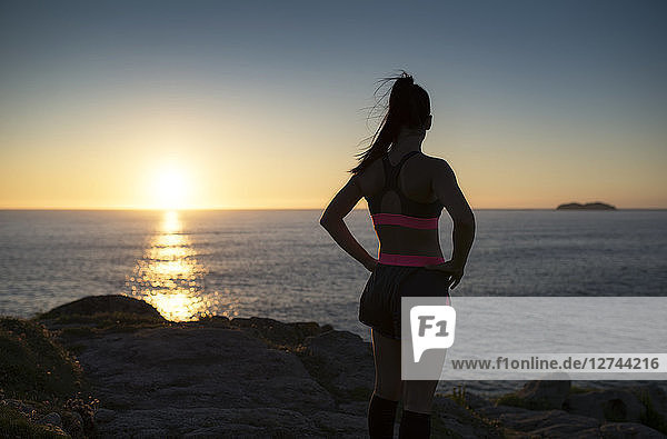 Sportive woman looking sunset