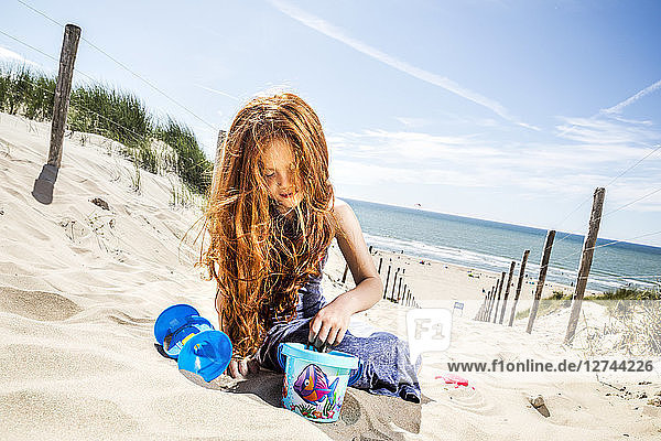Netherlands  Zandvoort  redheaded girl playing on the beach