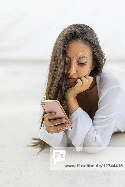 Portrait of young woman looking at cell phone