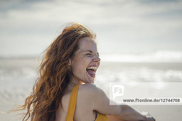 Laughing woman having fun on the beach