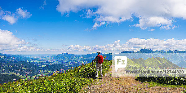 Germany  Allgaeu Alps  Hiker standing on path looking at panoramic road from Fellhorn to Sollereck mountain