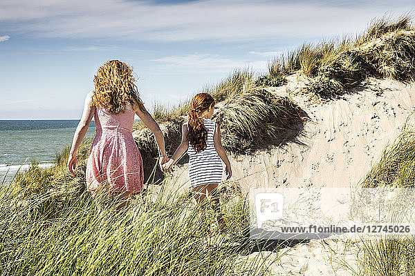 Netherlands  Zandvoort  mother and daughter walking in beach dunes