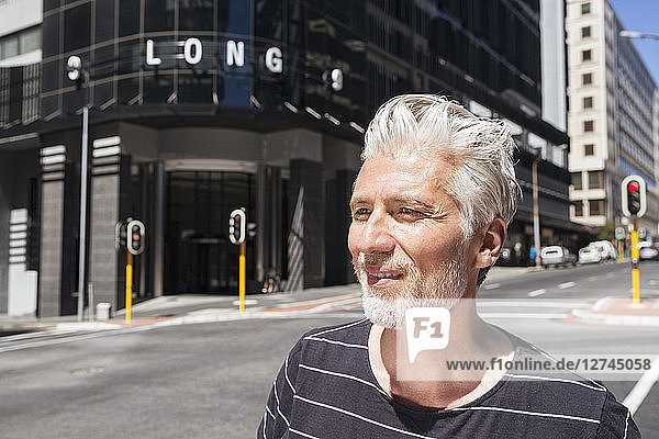 Portrait of a mature man  walking in the city