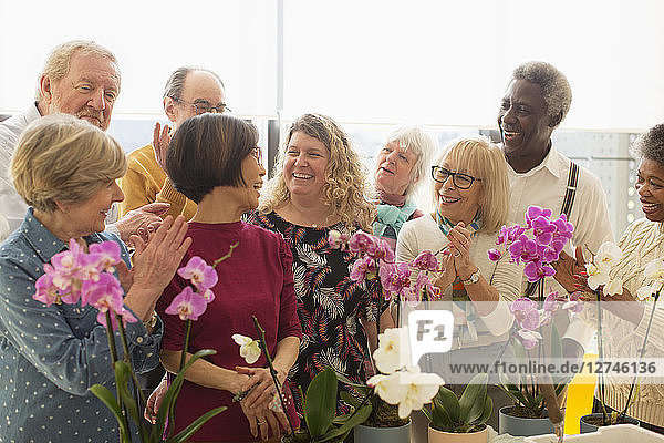 Happy active seniors enjoying flower arranging class
