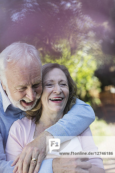 Affectionate  smiling senior couple hugging