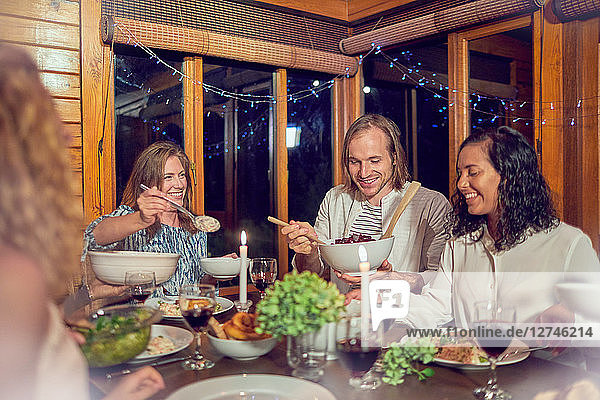 Friends enjoying dinner in cabin
