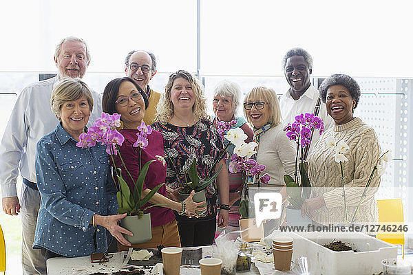 Portrait smiling active seniors enjoying flower arranging class