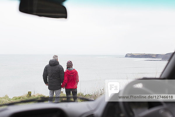 Ehepaar mit Blick auf das Meer außerhalb des Autos