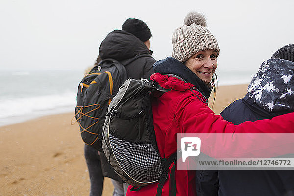 Portrait smiling woman with husband and son on winter beach