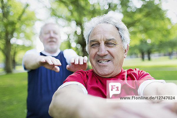 Active senior men exercising in park
