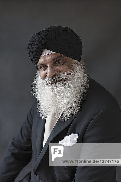 Portrait smiling  confident well-dressed senior man with beard in turban
