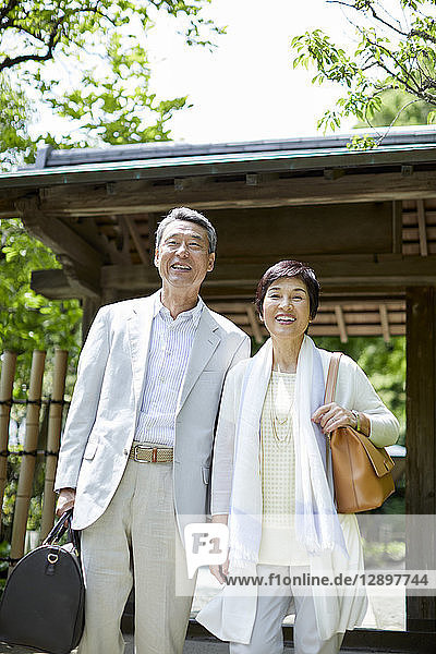 Japanese senior couple having fun at traditional inn