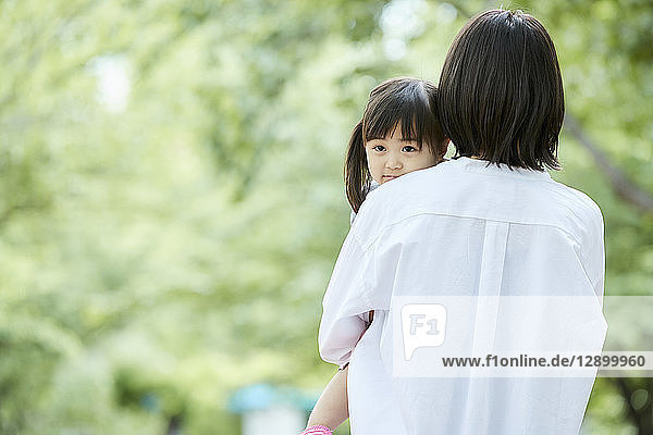 Japanese mother and daughter at a city park