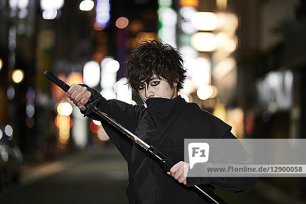 Japanese ninja at night downtown Tokyo