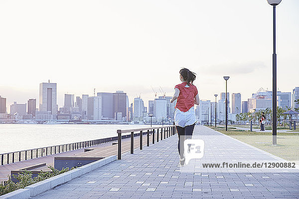 Young Japanese woman training downtown Tokyo
